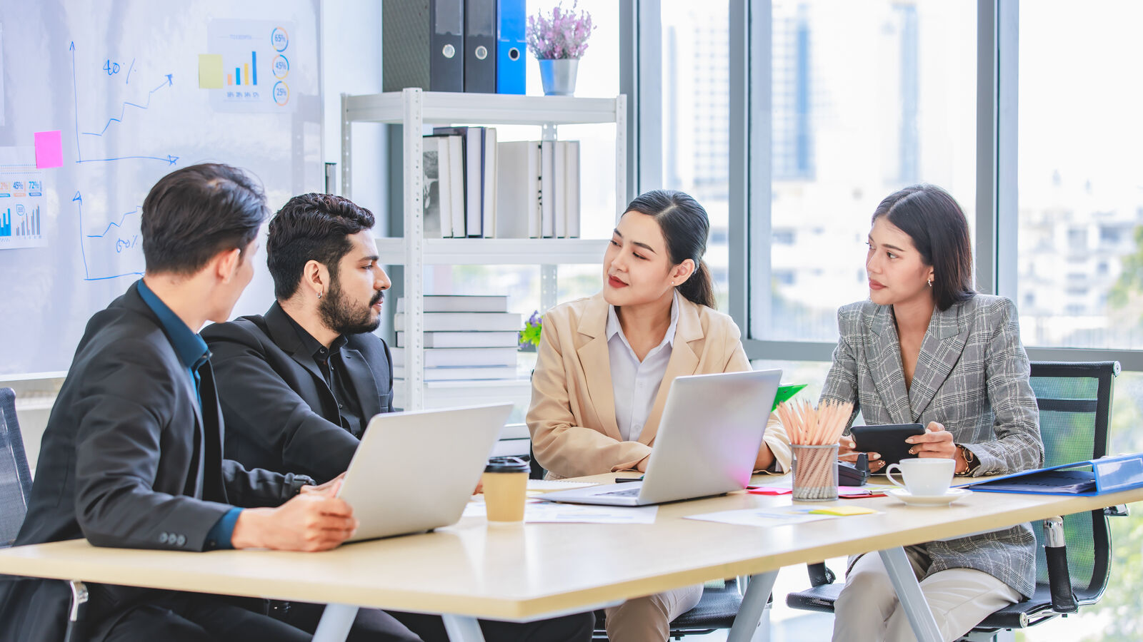 Colleagues talking around a meeting table